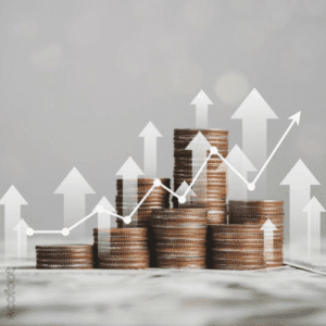 Stacks of coins arranged in ascending order with white arrows and a line graph overlay, symbolising rising costs or financial growth.