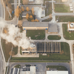 Aerial view of energy-efficient infrastructure with solar panels and emissions data.