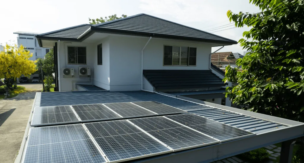 A modern Victorian house with rooftop solar panels installed under clear daylight.