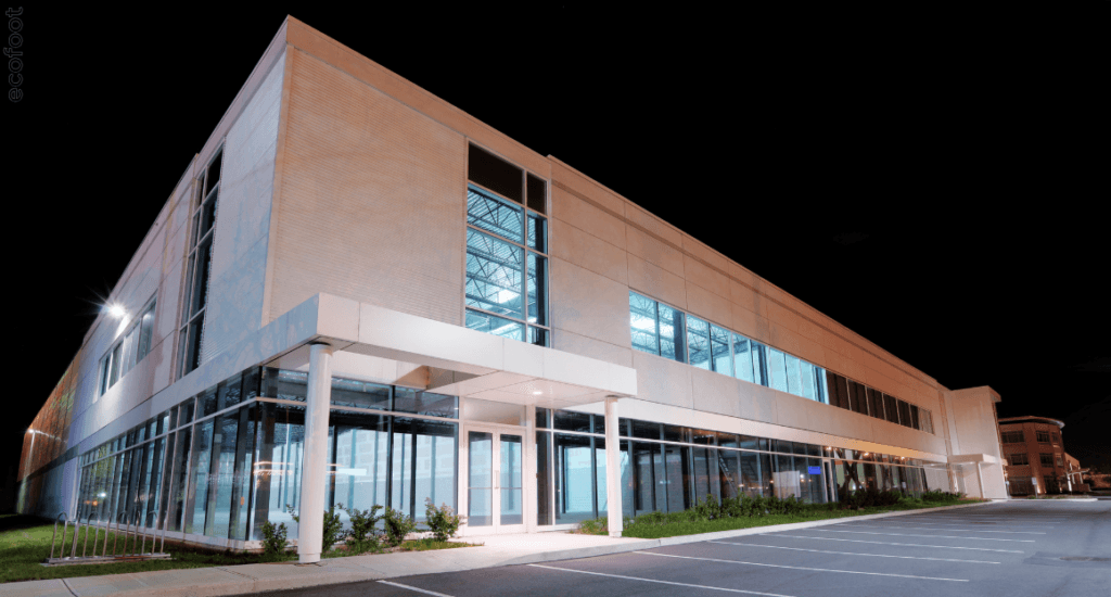 Exterior view of a modern commercial building in Victoria illuminated by energy-efficient LED lights at night, showcasing bright and sustainable lighting.