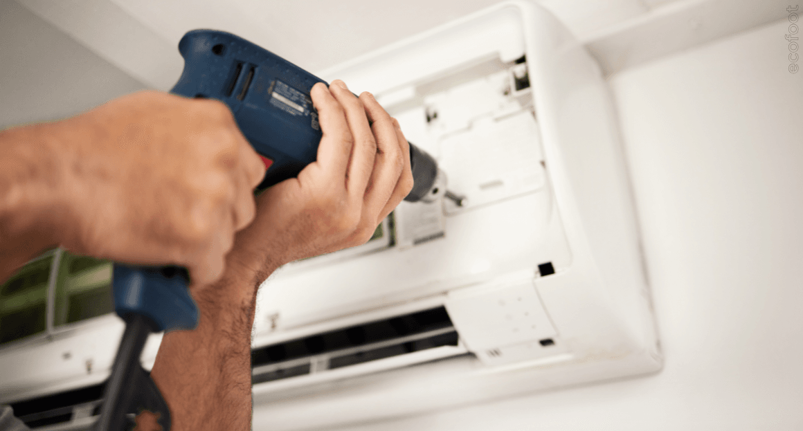 Text: Technician installing a reverse-cycle air conditioner in a Victorian home, supporting grid-friendly electric heating and energy-efficient upgrades. 