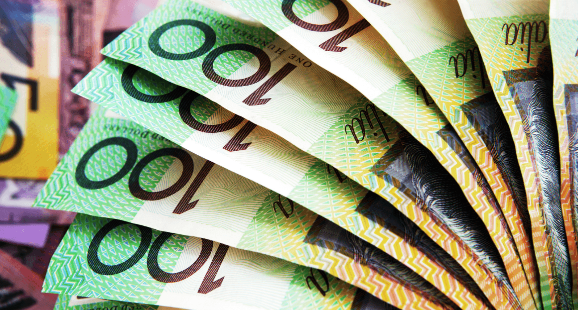 An image of Australian 100-dollar bills fanned out, illustrating government rebates and financial incentives. 