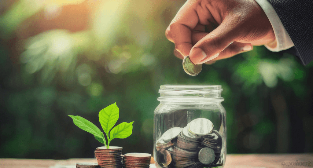 Hand placing a coin into a glass jar beside a growing plant, symbolising savings through the air conditioner rebate in Victoria.